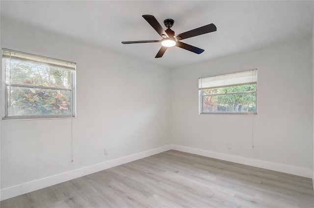 3100 Las Palmas Dr, Titusville, FL 32780 - spare room featuring healthy amount of natural light, light wood-style flooring, baseboards, and ceiling fan