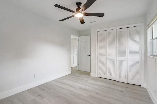 3100 Las Palmas Dr, Titusville, FL 32780 - unfurnished bedroom with light wood-type flooring, baseboards, a closet, and a ceiling fan