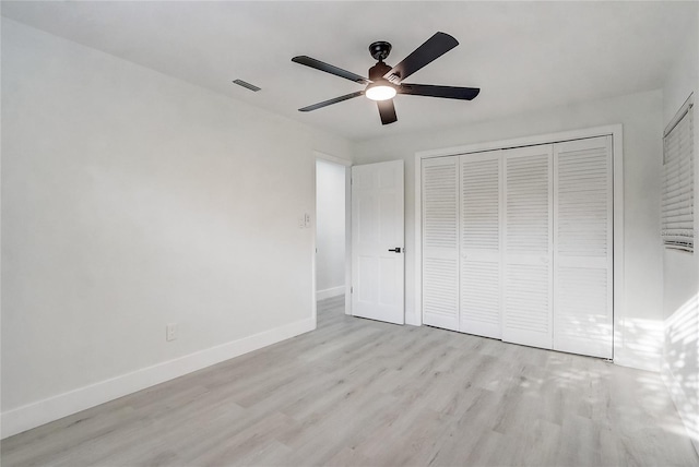 3100 Las Palmas Dr, Titusville, FL 32780 - unfurnished bedroom featuring light wood-style floors, baseboards, a closet, and ceiling fan