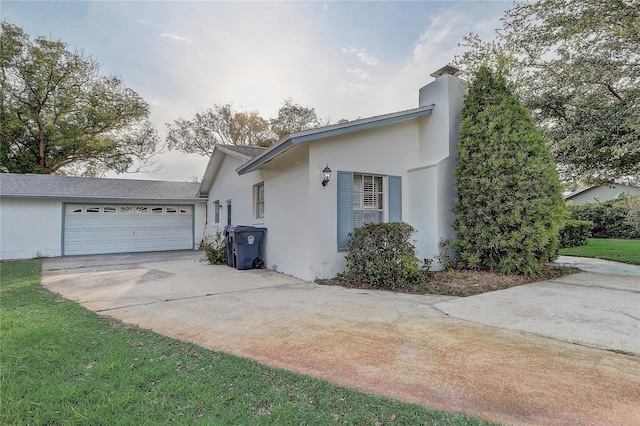3100 Las Palmas Dr, Titusville, FL 32780 - view of property exterior featuring driveway, an attached garage, a chimney, and a shingled roof