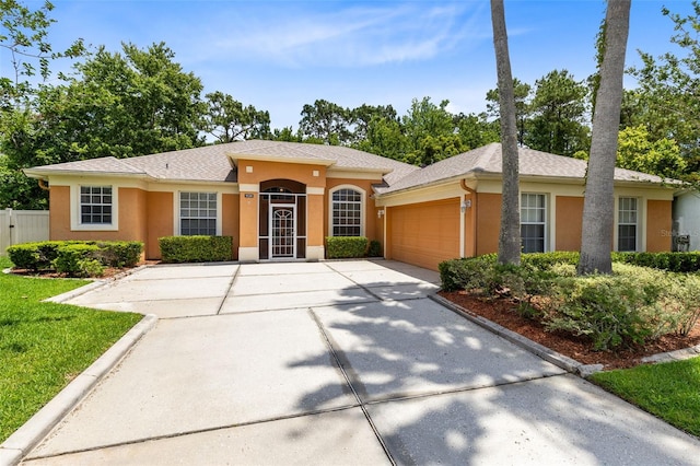 9330 Shadow Pinar Ct, Orlando, FL 32825 - ranch-style home with concrete driveway, an attached garage, and stucco siding