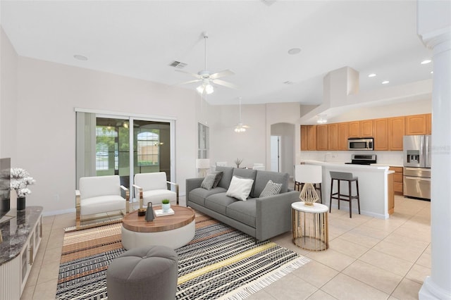 9330 Shadow Pinar Ct, Orlando, FL 32825 - living room with light tile patterned floors, a ceiling fan, recessed lighting, arched walkways, and baseboards
