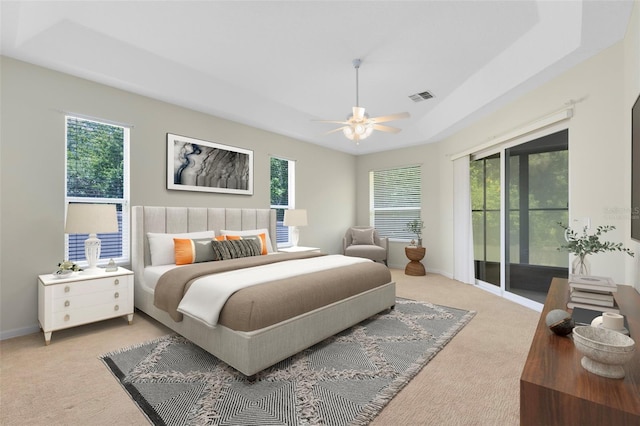 9330 Shadow Pinar Ct, Orlando, FL 32825 - bedroom with light carpet, access to exterior, a raised ceiling, and multiple windows