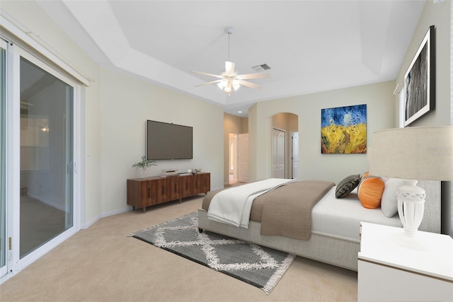 9330 Shadow Pinar Ct, Orlando, FL 32825 - bedroom with arched walkways, light carpet, baseboards, and a ceiling fan