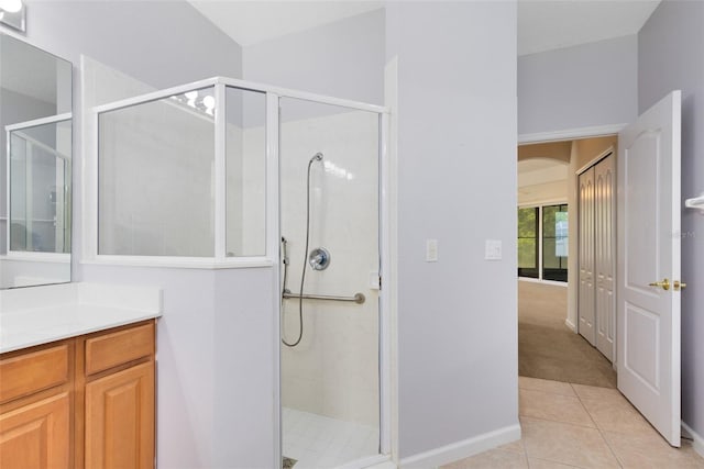 9330 Shadow Pinar Ct, Orlando, FL 32825 - bathroom with a stall shower, tile patterned floors, vanity, and baseboards