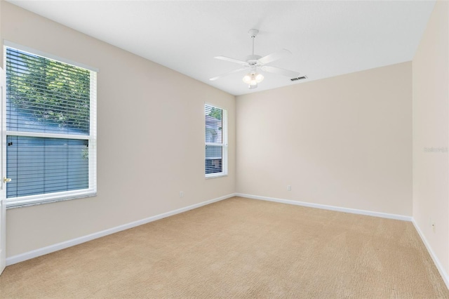 9330 Shadow Pinar Ct, Orlando, FL 32825 - spare room featuring light colored carpet, baseboards, and a ceiling fan