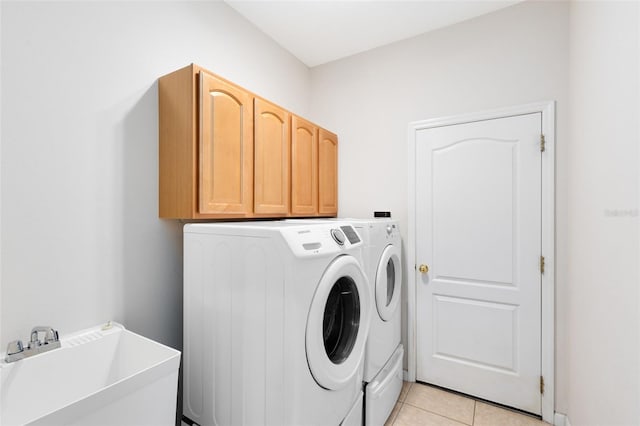 9330 Shadow Pinar Ct, Orlando, FL 32825 - washroom with washing machine and dryer, cabinet space, and light tile patterned flooring