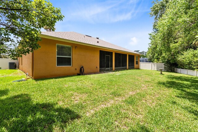9330 Shadow Pinar Ct, Orlando, FL 32825 - rear view of property with central AC, a sunroom, and stucco siding