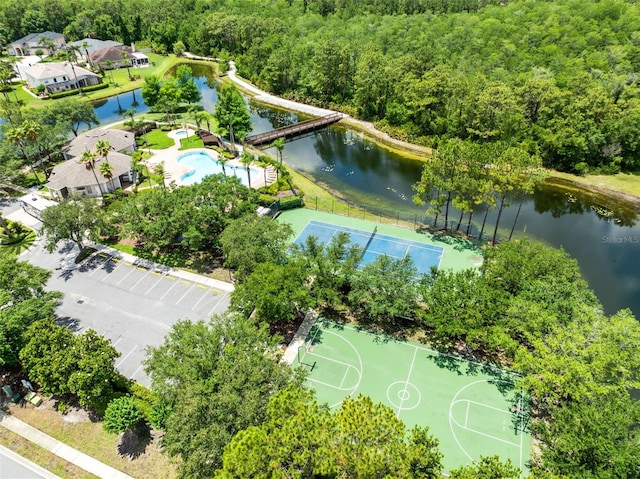 9330 Shadow Pinar Ct, Orlando, FL 32825 - bird's eye view of a pool area, a heavily wooded area, and a large body of water