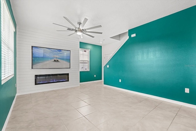 3039 Meleto Blvd, New Smyrna Beach, FL 32168 - unfurnished living room with a fireplace, a ceiling fan, baseboards, and tile patterned flooring