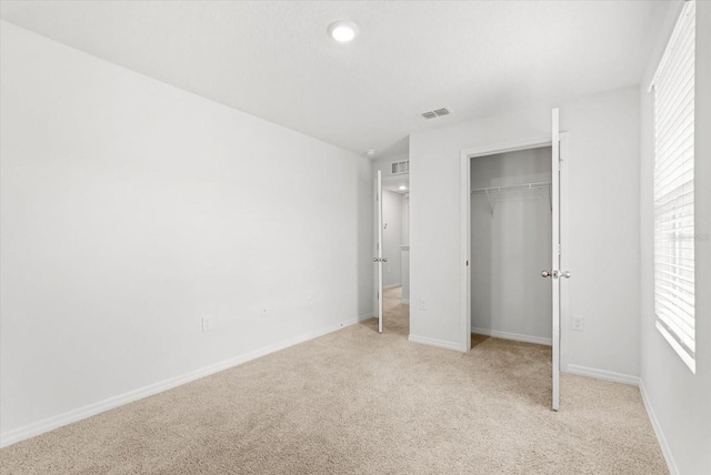 3039 Meleto Blvd, New Smyrna Beach, FL 32168 - unfurnished bedroom with light carpet, multiple windows, baseboards, and recessed lighting