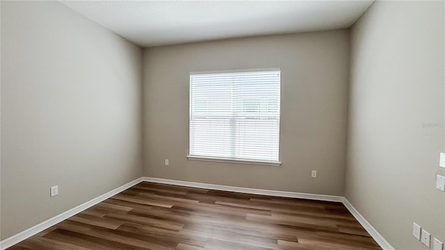 9917 Summerlake Groves St, Winter Garden, FL 34787 - spare room featuring healthy amount of natural light, dark wood-type flooring, and baseboards