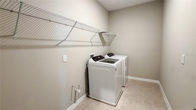 9917 Summerlake Groves St, Winter Garden, FL 34787 - washroom with washing machine and dryer, baseboards, and light tile patterned floors