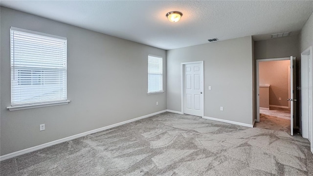 9917 Summerlake Groves St, Winter Garden, FL 34787 - unfurnished bedroom featuring carpet, baseboards, and a textured ceiling