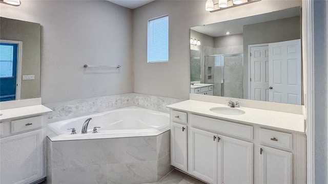 9917 Summerlake Groves St, Winter Garden, FL 34787 - full bathroom featuring a shower stall, two vanities, and a bath