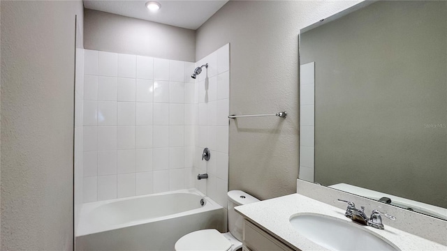 9917 Summerlake Groves St, Winter Garden, FL 34787 - full bath featuring toilet, a textured wall, vanity, and washtub / shower combination