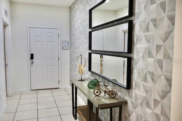 tiled entrance foyer with baseboards