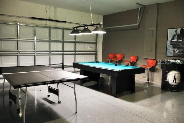 playroom featuring speckle patterned floor and pool table
