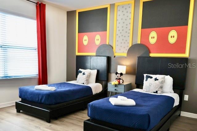 bedroom featuring wood finished floors and baseboards