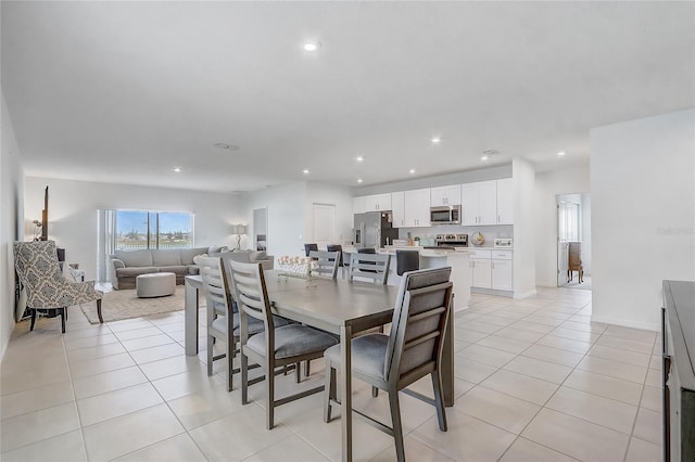 dining space with light tile patterned floors and recessed lighting