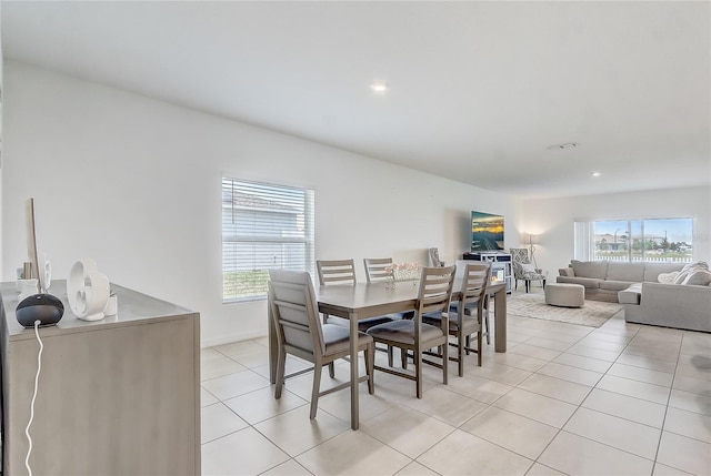 dining area featuring plenty of natural light, light tile patterned floors, recessed lighting, and baseboards