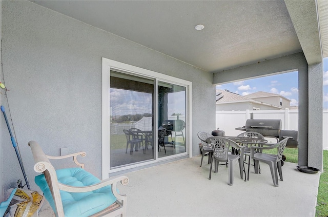 view of patio with fence and outdoor dining area