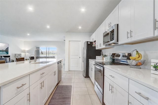 392 Citrine Loop, Kissimmee, FL 34758 - kitchen with stainless steel appliances, white cabinets, light countertops, recessed lighting, and light tile patterned floors