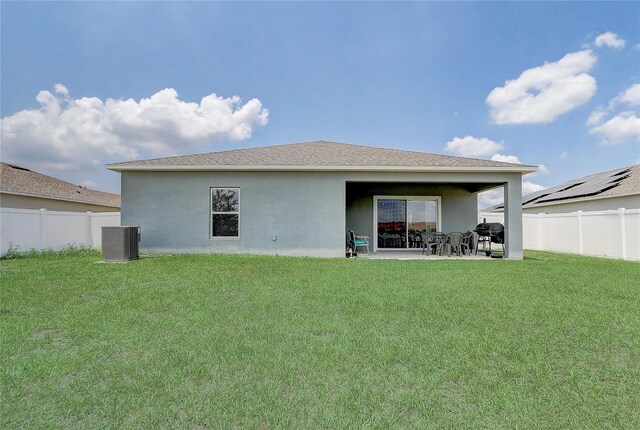 392 Citrine Loop, Kissimmee, FL 34758 - back of house featuring a fenced backyard, a patio, and stucco siding