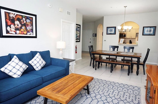 2785 Almaton Loop Unit 204, Kissimmee, FL 34747 - living room with arched walkways, a chandelier, light tile patterned flooring, and baseboards