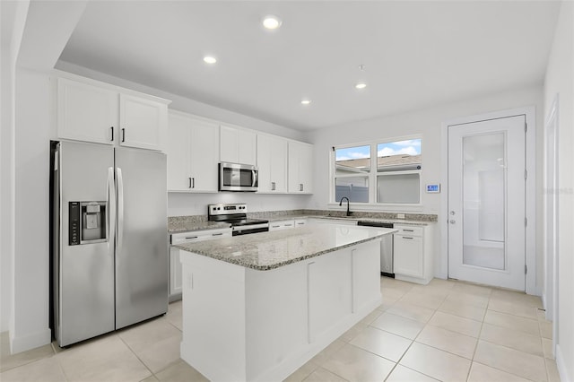 14538 Orchid Island Dr, Orlando, FL 32827 - kitchen featuring stainless steel appliances, a sink, a center island, white cabinets, and recessed lighting