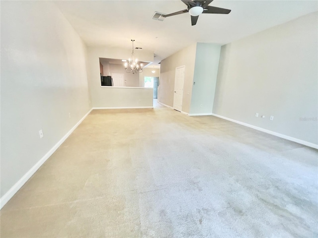 unfurnished room with a chandelier, a ceiling fan, baseboards, and carpet flooring