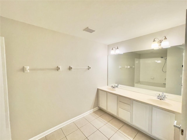 full bathroom with tile patterned flooring, baseboards, double vanity, and washtub / shower combination