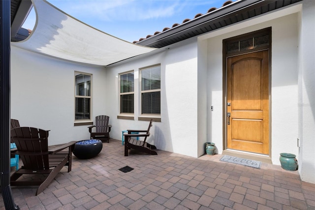 16696 Otterchase Ln, Winter Garden, FL 34787 - property entrance with stucco siding, a patio area, and a tile roof
