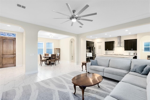 16696 Otterchase Ln, Winter Garden, FL 34787 - living room with arched walkways, recessed lighting, a ceiling fan, and baseboards