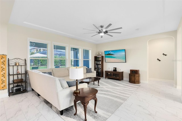 16696 Otterchase Ln, Winter Garden, FL 34787 - living area with light marble finish flooring, ceiling fan, baseboards, and arched walkways