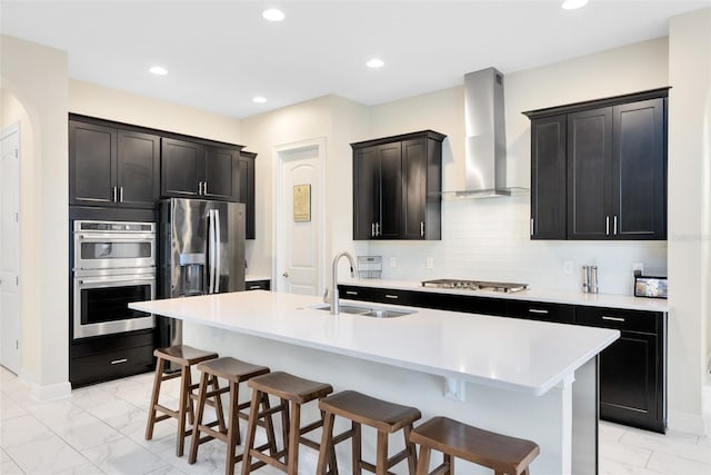 16696 Otterchase Ln, Winter Garden, FL 34787 - kitchen featuring a sink, wall chimney exhaust hood, stainless steel appliances, a breakfast bar area, and light marble finish floors