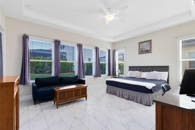 16696 Otterchase Ln, Winter Garden, FL 34787 - bedroom with a raised ceiling, baseboards, light marble finish floors, and a ceiling fan