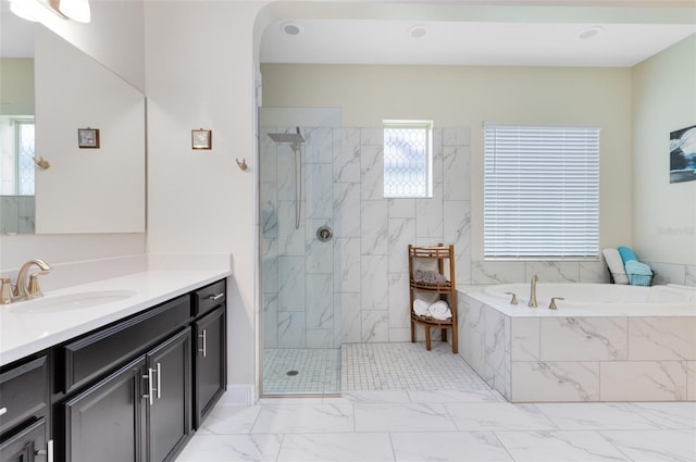 16696 Otterchase Ln, Winter Garden, FL 34787 - full bathroom with marble look tile flooring, a bath, vanity, and a marble finish shower