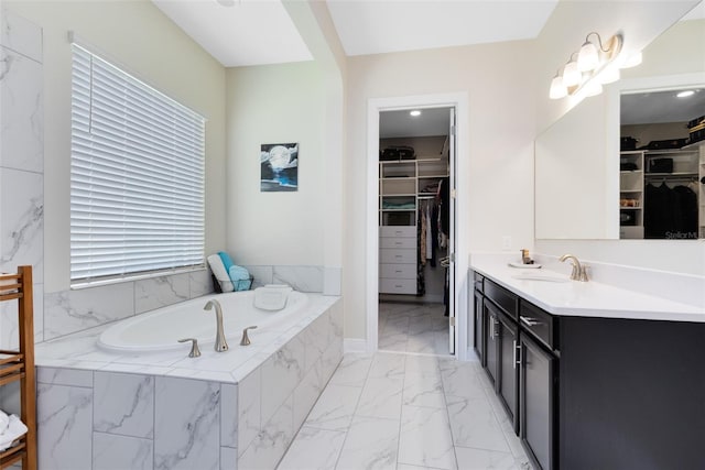 16696 Otterchase Ln, Winter Garden, FL 34787 - full bathroom featuring marble finish flooring, vanity, a garden tub, and a spacious closet