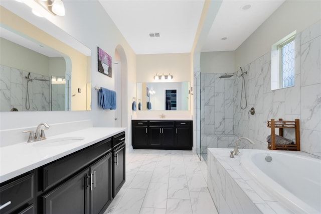 16696 Otterchase Ln, Winter Garden, FL 34787 - bathroom featuring marble look tiles, a marble finish shower, a garden tub, and two vanities