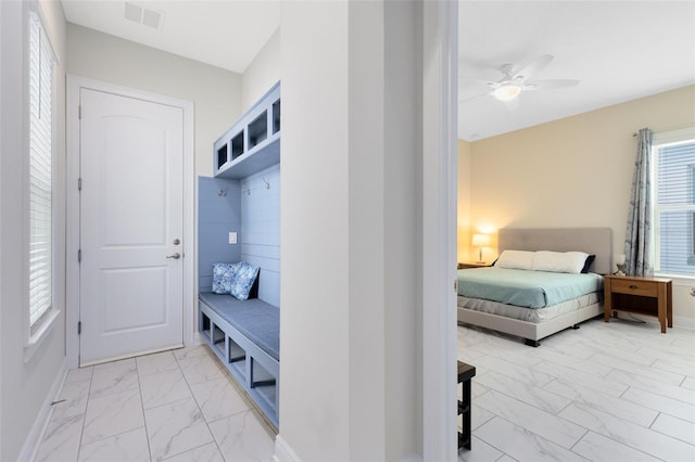 16696 Otterchase Ln, Winter Garden, FL 34787 - mudroom featuring light marble finish floors, baseboards, and ceiling fan