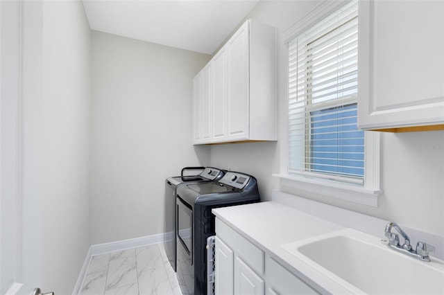 16696 Otterchase Ln, Winter Garden, FL 34787 - clothes washing area featuring washer and clothes dryer, cabinet space, light marble finish floors, and baseboards