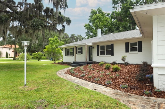 656 Lake Charm Dr, Oviedo, FL 32765 - ranch-style home featuring a front lawn, roof with shingles, and a chimney