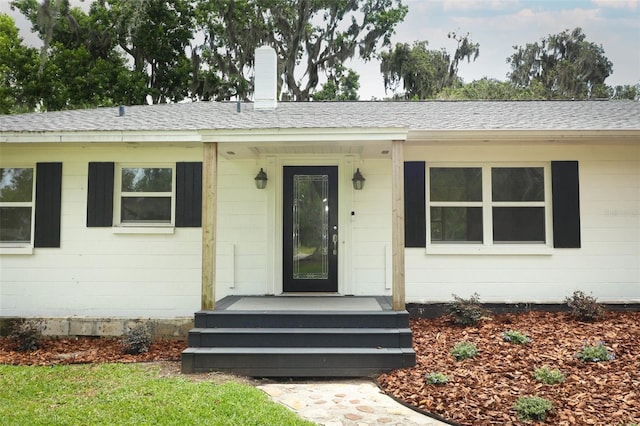 656 Lake Charm Dr, Oviedo, FL 32765 - entrance to property featuring roof with shingles and a chimney