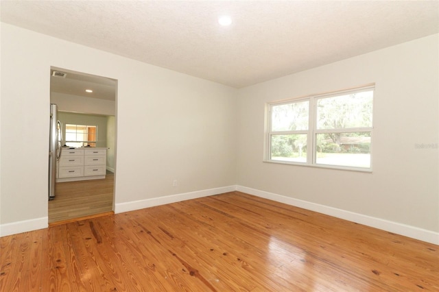 656 Lake Charm Dr, Oviedo, FL 32765 - spare room featuring baseboards, healthy amount of natural light, light wood-style floors, and recessed lighting
