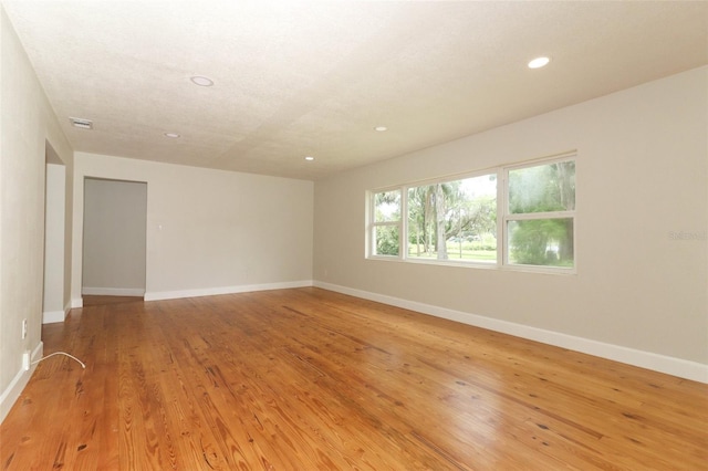 656 Lake Charm Dr, Oviedo, FL 32765 - spare room with baseboards, recessed lighting, and light wood-style floors