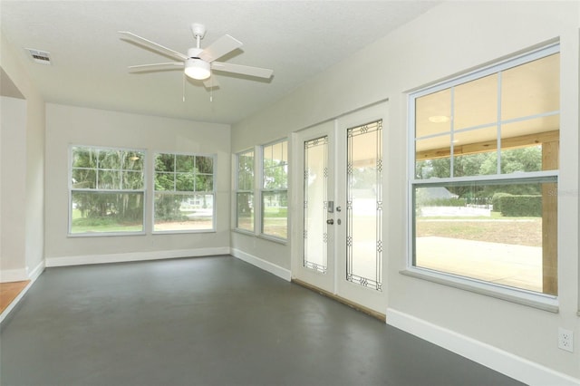 656 Lake Charm Dr, Oviedo, FL 32765 - unfurnished sunroom featuring baseboards, concrete floors, and plenty of natural light