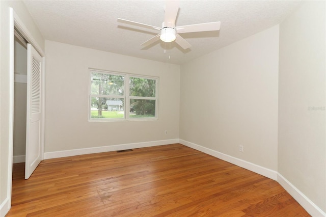 656 Lake Charm Dr, Oviedo, FL 32765 - unfurnished bedroom with light wood finished floors, a closet, baseboards, and a ceiling fan