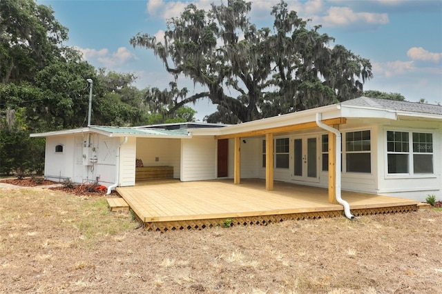 656 Lake Charm Dr, Oviedo, FL 32765 - back of house with french doors, a deck, and metal roof