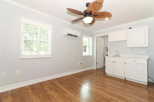 656 Lake Charm Dr, Oviedo, FL 32765 - kitchen featuring a wall unit AC, a sink, healthy amount of natural light, crown molding, and light countertops